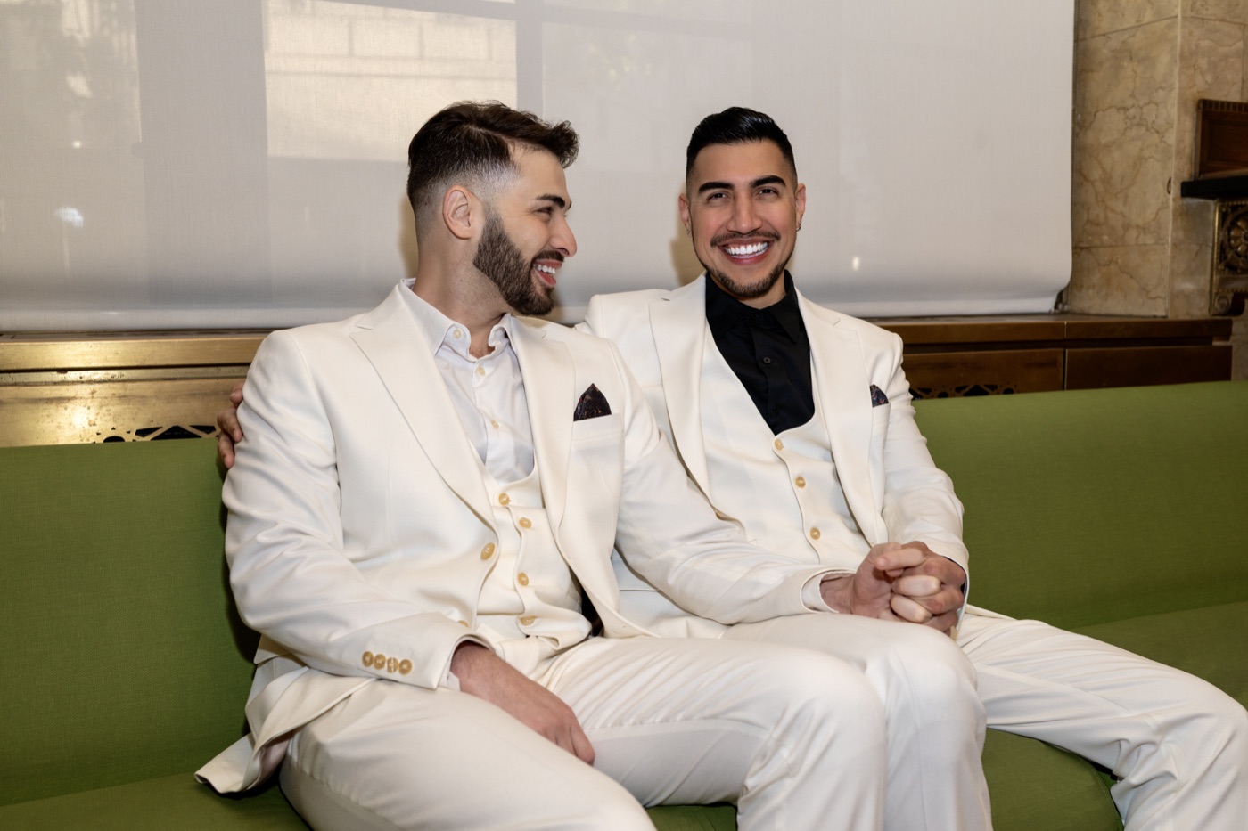 Two grooms seated together during an intimate celebration